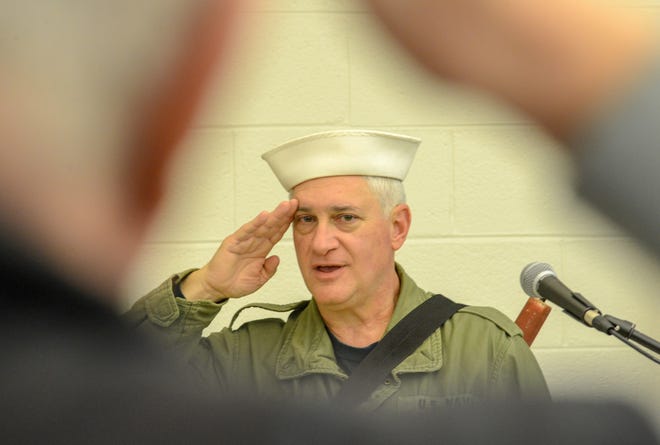 Jim Iaia, a teacher at Keith Valley, salutes during the pledge of allegiance before active duty and retired veterans were served breakfast by students in recognition of Veterans Day on Friday at Keith Valley Middle School in Horsham. [WILLIAM THOMAS CAIN / PHOTOJOURNALIST]
