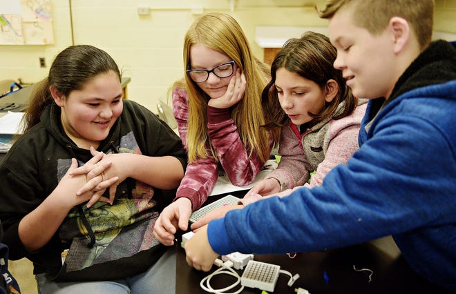 Sixth-graders Alaina Collo, left, Megan Mendler, Kaylee Acquavia and Trevor Beach work on creating circuitry to design code during STEM career day at Neil A. Armstrong Middle School in Bristol Township on Thursday. [KIM WEIMER / STAFF PHOTOJOURNALIST]
