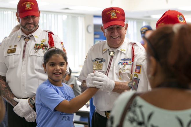 Student Daniela Fleites gets a photo with veteran Steve Szapor of the Mount Dora VFW during the Veterans Day Ceremony at Triangle Elementary School in Mount Dora on Friday. [Cindy Sharp/Correspondent]