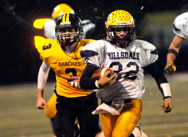 Hillsdale's Garrett Smith (22) sprints away from Fairview's Cade Ripke on his third-quarter touchdown run of 36 yards in a Div. VI, Region 22 playoff game Friday at Findlay. The Apaches scored with 1:17 to play and edged the Falcons 32-26.