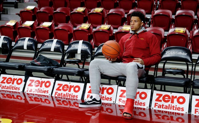 Injured Iowa State guard Lindell Wigginton sits on the bench before Friday's game against Missouri. [Charlie Neibergall/The Associated Press]
