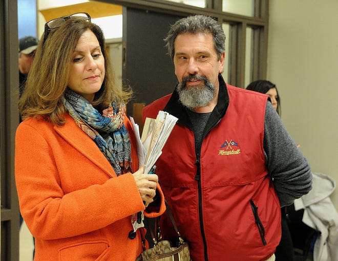 Dawn Saurette and Joseph Pereira stand in line at the Fall River city clerk's office waiting to drop off some of the recall petitions on Friday afternoon. [Herald News Photo | Dave Souza]