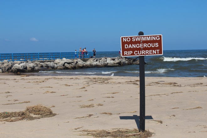 Holland State Park posted no swimming signs are posted around the piers, along with a colored warning flag system. This year is the first year since at least 2010 with over 100 Great Lakes drowning deaths. [Erin Dietzer/Sentinel staff]