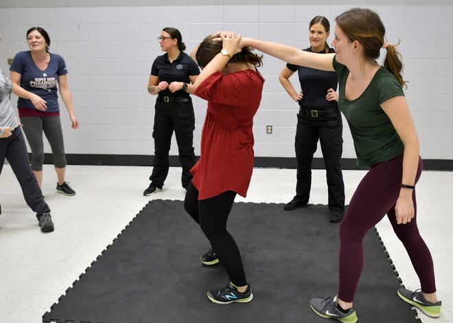 Landmark Reporter Rachel Ettlinger (left) and Editor Rebecca Humphrey (right) take part in a self-defense workshop offered by the Worcester County Sheriff's Office and The Vanessa T. Marcotte Foudnation. During the active workshop, participants practiced realistic self-defense tactics, learned situational awareness skills and how to handle a confrontation both verbally and mentally. [T&G Staff/Christine Peterson]