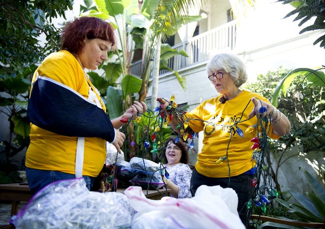 Fellowship Friday volunteers, from left, Kristin Landon Bev Bracken and Grace Landon untangle holiday lights in preparation for Festival of Trees at the Ann Norton Sculpture Gardens in 2016. [Meghan McCarthy/palmbeachdailynews.com]