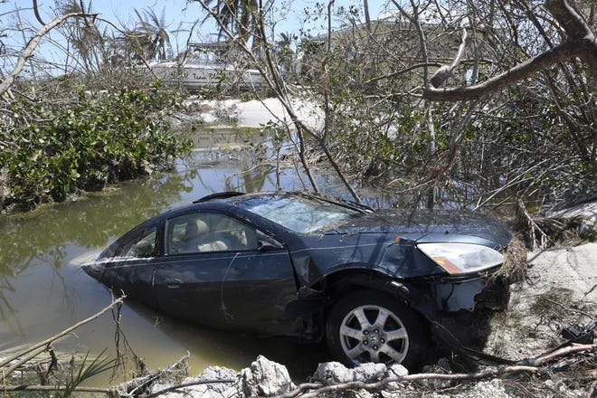 Hurricanes Irma in Florida and Harvey in Texas last year left behind a large number of flood-damaged vehicles that are now appearing with "for sale" signs. [Sun Sentinel, file / Taimy Alvarez]