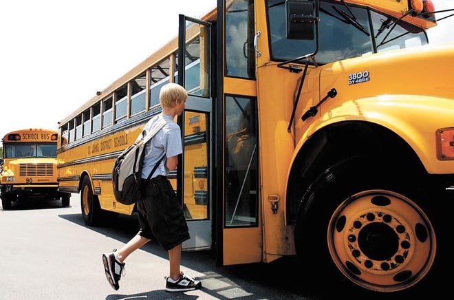 A student boards a St. Johns County school buses at Murray Middle School. St. Johns County Sheriff’s Office spokesperson Chuck Mulligan says the sheriff’s office receives “numerous complaints” each week from concerned drivers who report others running school bus stop signs or speeding through school zones. [RECORD FILE]