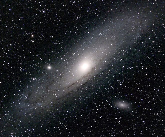 Andromeda Galaxy, M31, is shown with its two brightest satellite galaxies: M32 is to the left of center and M110 is to the bottom right of the center.

[Torben Hansen/ Wikimedia Commons]