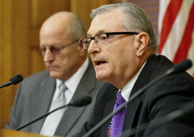 Legislative research director Raney Gilliland, right, and budget director Larry Campbell share a revenue forecast update for the current and next fiscal years Friday afternoon at the Kansas Statehouse. [Chris Neal/The Capital-Journal]