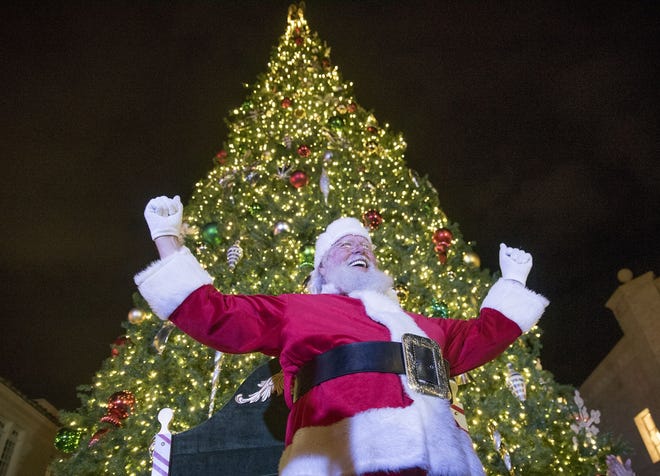 Santa Claus cheers as he finishes the countdown prompting the lighting of the 40-foot-tall Christmas Tree on Worth Avenue in November 2017. This year's tree will be installed beginning Friday. [Andres Leiva/Daily News file photo]
