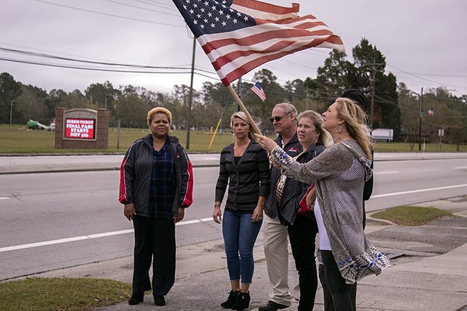 Havelock residents pay their respects as Army National Guard Sgt. James Slape's motorcade departs Cherry Point for Morehead City. Slape was killed in 

Afghanistan last month.  [KEITH BYERS PHOTOS/GATEHOUSE MEDIA]
