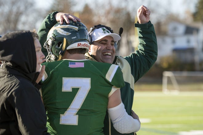 Nashoba head coach Jamie Tucker celebrates with quarterback Sam Bolinsky after Bolinsky ran in for a touchdown during the Central Division 4 championship game against Tantasqua Regional at Foley Field in Worcester, Nov. 10, 2018. The Chieftains beat the Warriors, 28-0.  [Wicked Local Staff Photo/John Walker]