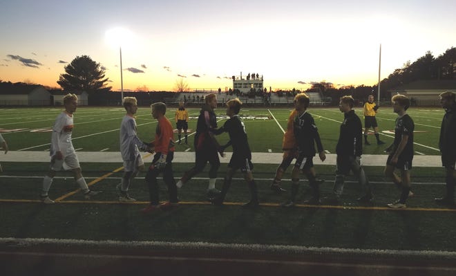 The Walpole and Westwood boys soccer teams shake hands after Saturday's Division 2 South semifinal, a 3-1 win for the Rebels. Wicked Local Photo.