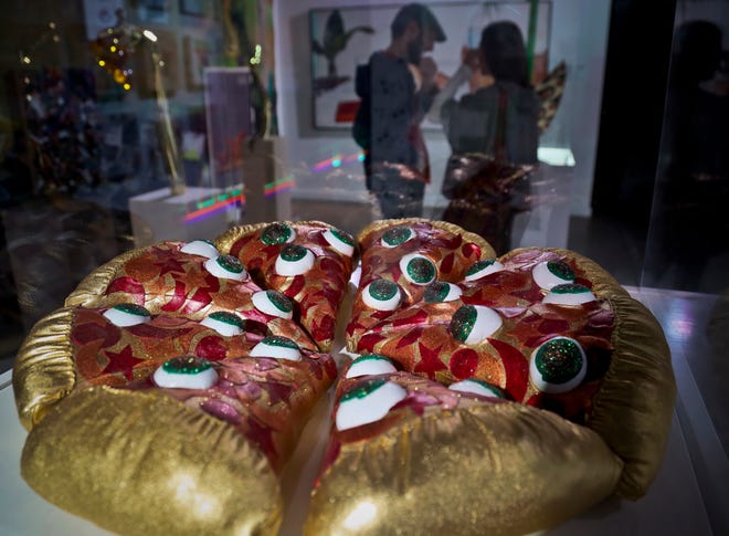 This Nov. 2, 2018 photo shows a textile sculpture from artist Hein Koh called "Mystic Pizza," part of a group art exhibition celebrating pizza at The Museum of Pizza in New York. (AP Photo/Bebeto Matthews)