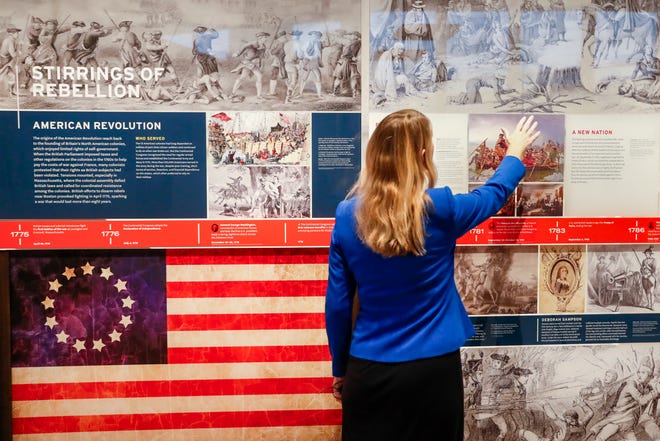 A staff member browses a display during a limited media availability at the National Veterans Museum and Memorial in Columbus.