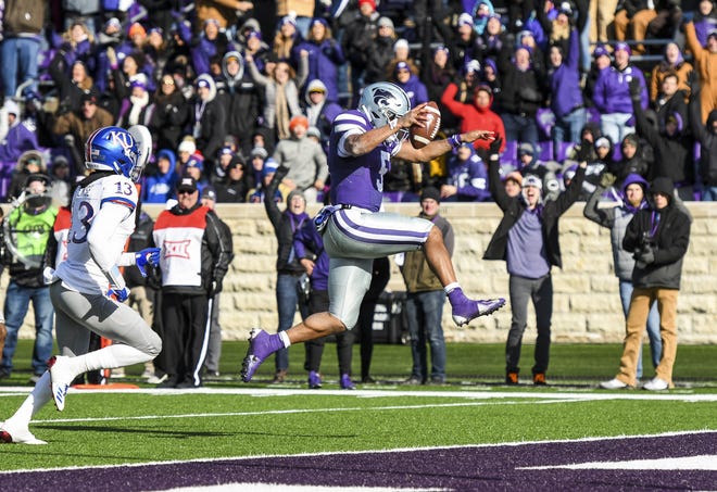 Kansas State quarterback Alex Delton leaps into the end zone to put the Wildcats up for good Saturday during the Sunflower Showdown against Kansas in Manhattan. K-State won 21-17. [Emily DeShazer/Special to The Capital-Journal]