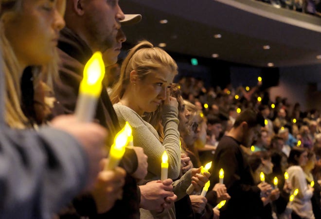 People gather to pray for the victims of a mass shooting during a candlelight vigil in Thousand Oaks, Calif., Thursday, Nov. 8, 2018. A gunman opened fire Wednesday evening inside a country music bar, killing multiple people including a responding sheriff's sergeant. (AP Photo/Ringo H.W. Chiu)