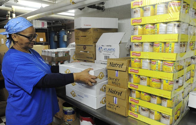 Site manager Joanne Sbardella checks inventory at the Greater Fall River Community soup kitchen on Tuesday. [Herald News Photo | Dave Souza]