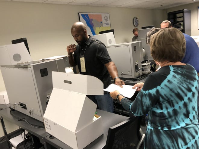 Sarasota County elections workers proceed with a machine recount on Tuesday. [Herald-Tribune staff photo / Nicole Rodriguez]