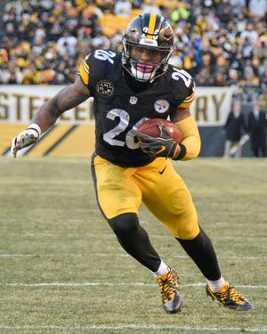 FILE - In this Jan. 14, 2018, file photo, Pittsburgh Steelers running back Le'Veon Bell (26) heads for the end zone after taking a pass from quarterback Ben Roethlisberger during the second half of an NFL divisional football AFC playoff game against the Jacksonville Jaguars, in Pittsburgh. The Le'Veon Bell watch is almost over for the Steelers. The star running back has until 4 p.m. on Tuesday, Nov. 13, 2018, afternoon to sign his one-year franchise tender and be eligible to play this season. (AP Photo/Don Wright, File)