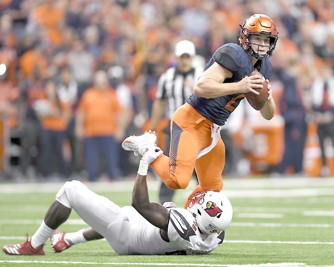 Syracuse quarterback Eric Dungey (top) tries to break the grasp of Louisville defensive end Tabarius Peterson during the first half of a Nov. 9 game in the Carrier Dome.     

[Adrian Kraus / Associated Press]