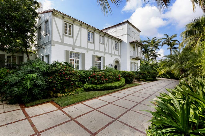 At 240 Jungle Road in Palm Beach, this 1920s-era Norman Revival-style house has sold for $8.2 million, the price recorded Tuesday with the deed by the Palm Beach County Clerk's office. The landmarked proeprty is attributed to noted society architect Maurice Fatio. [Photo by Edward Butera, IBI Designs, courtesy Premier Estate Properties]