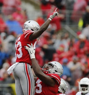 Left tackle Thayer Munford holds up receiver Terry McLaurin after a touchdown against Rutgers. Munford said he believes he has done a good job in his role as a starter. “I know I’ve had some hiccups here and there, but I’m learning from that,” he said. [Jonathan Quilter/Dispatch]