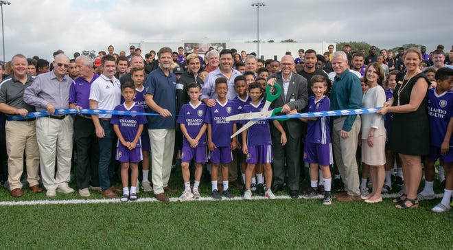 The ribbon is cut on Montverde Academy's new soccer field on Saturday. The new field was immediately put to use with a full day of games. [Submitted]