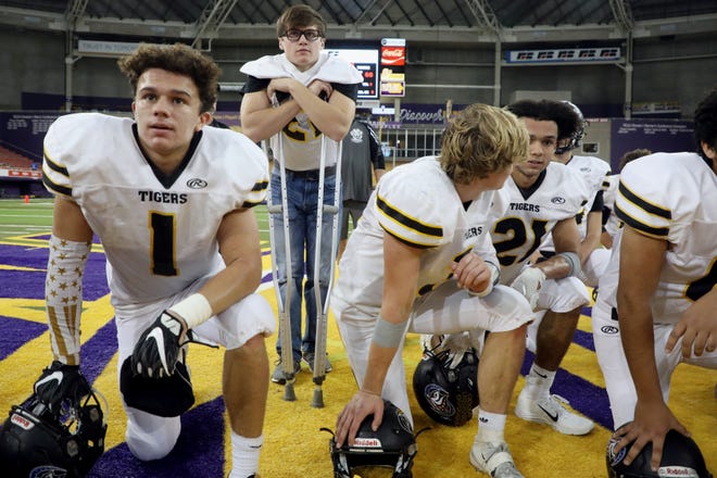 New London High School's Shae Summerfield, on crutches, huddles with his teammates during their 8-Player state semifinal game against Fremont-Mills last week at the UNI-Dome in Cedar Falls. Summerfield fractured his hip during the team's homecoming game early in the year. [John Lovretta/thehawkeye.com]
