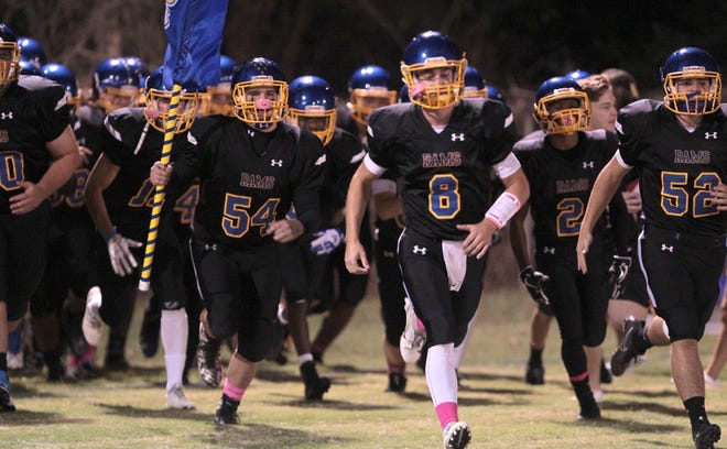 Senior quarterback Caleb Hill (8) and Highland Tech enter the field on Oct. 19 for their homecoming game against Cherryville on Oct. 19. [Mike Hensdill/The Gaston Gazette]
