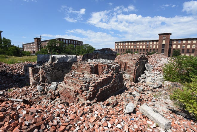 Brick piers and granite trim pieces, part of the foundation of the former Weaver Mill, now owned by SSTAR, are seen Friday, July 13, 2018. [Herald News Photo | Jack Foley]