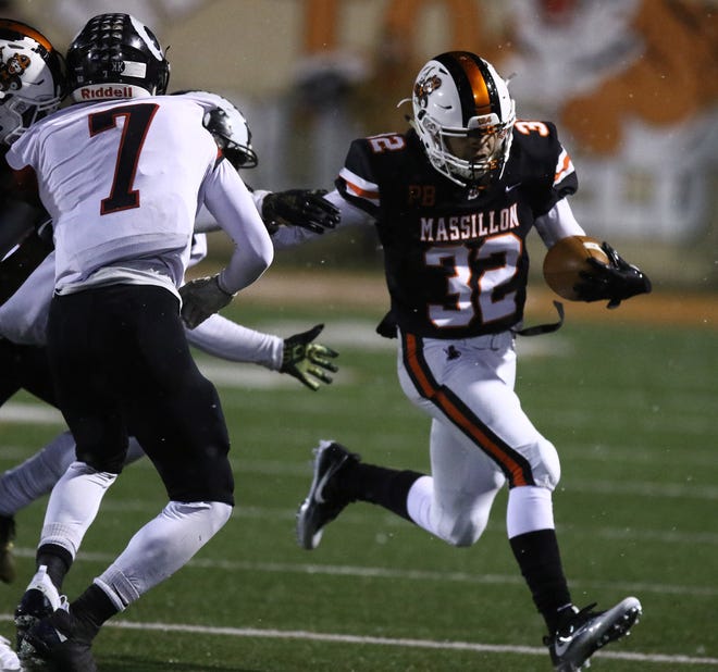 Massillon's Aydrik Ford (32) looks for room to run after a catch in the regional-semifinal win over Whitehall-Yearling. (IndeOnline.com/ Kevin Whitlock)