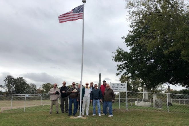 Some of the people who were involved with installing a flagpole honoring veterans at St. John Catholic Cemetery in LaSalle. (Courtesy photo)