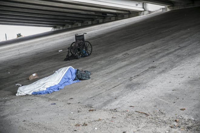 A homeless person finds shelter Tuesday under Highway 71 in Austin. Temperatures dropped to below freezing earlier this week. [RICARDO B. BRAZZIELL/AMERICAN-STATESMAN]