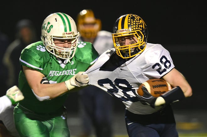 Mogadore's Logan Penix grabs and takes down Kirtland's Luke Gardner on Friday, Nov. 16 to stop a good gain. [Kevin Graff/Record-Courier]