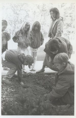 Students at the Marstons Mills East Elementary School plant bulbs on the school grounds in the fall of 1988. [BARNSTABLE PATRIOT FILES/W.B. NICKERSON CAPE COD HISTORY ARCHIVES]