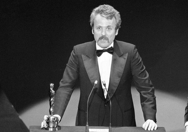 William Goldman accepts his Oscar at Academy Awards in Los Angeles, for screenplay from other medium for "All The President's Men." Goldman, the Oscar-winning screenplay writer died, Friday, Nov. 16, 2018. He was 87. [AP Photo]