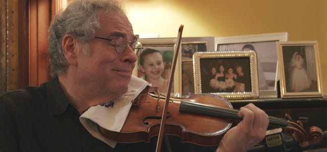 Renowned violinist Itzhak Perlman, shown here in this photo from the documentary "Itzhak," will join the Pittsburgh Symphony Orchestra in a free concert to honor the victims of the Tree of Life synagogue shooting in Squirrel Hill. The concert, aimed at helping the community heal, has a four-ticket-per-person limit. [Courtesy of Greenwich Entertainment]