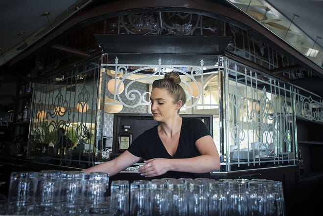 Danielle Oakley, a new bartender at Maven restaurant on Royal Poinciana Way, organizes mats behind the bar Thursday, Nov. 15, 2018. The restaurant is set to open for the season on Monday. [Damon Higgins/palmbeachdailynews.com]