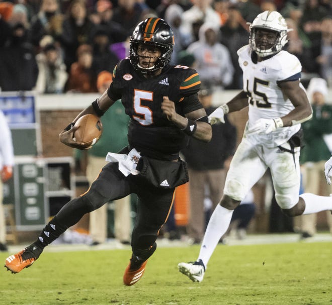 Miami quarterback N'Kosi Perry runs the ball during the Hurricanes' 27-21 loss at Georgia Tech on Saturday. (AP Photo/John Amis)