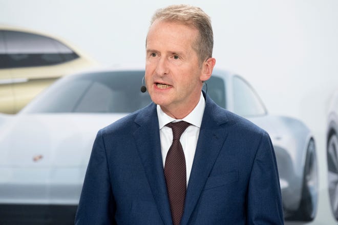 Volkswagen CEO Herbert Diess attends a news conference in Wolfsburg on Friday. German automaker Volkswagen says it will invest 44 billion euros ($50 billion) in developing autonomous and electric cars. [Julian Stratenschulte/dpa via AP]