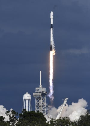 A SpaceX Falcon 9 rocket, like this one seen lifting off from Kennedy Space Center in 2017, is scheduled to carry a UNCW-designed satellite into orbit on Monday. [AP FILE PHOTO]