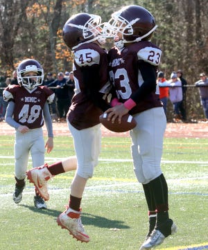 Adrian Peebles celebrates his touchdown with Ronan Pyne Sunday during the MMC D6 Mites win over Rockland in the OCYFL Super Bowl. [David Morrison/The Gazette/SCMG]