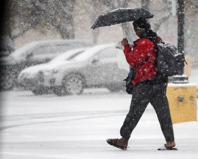 A pedestrian makes their way through a parking lot along South Main Street in Wilkes Barre, Pa., during a snowstorm, Thursday, Nov. 15, 2018. (Dave Scherbenco/The Citizens' Voice via AP)