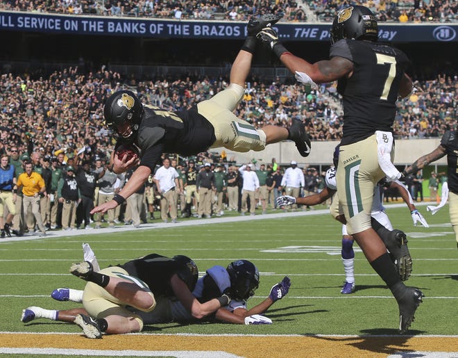Baylor quarterback Charlie Brewer dives over the goal line for a touchdown against TCU at McLane Stadium. (Michael Bancale/Waco Tribune Herald)
