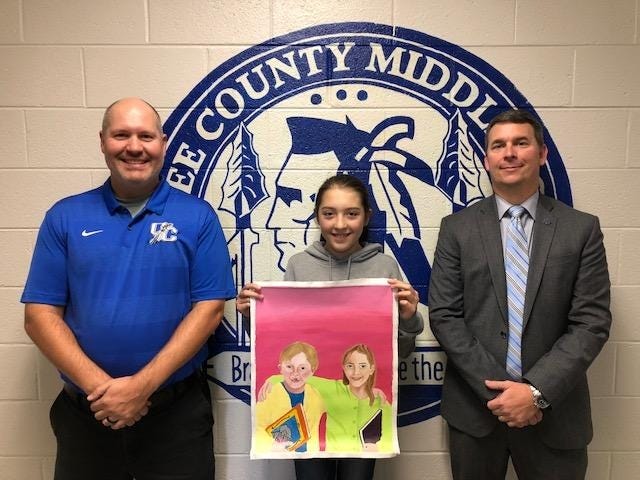 Pictured from Oconee Middle School, left to right, are Chad Willingham, art teacher, Cassidy Ruiz, winner, and Keith Carter, principal. [Contributed]