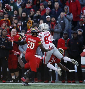 Ohio State receiver Terry McLaurin extends to make a catch against Maryland defensive back Antwaine Richardson during the second quarter. [Kyle Robertson/Dispatch]