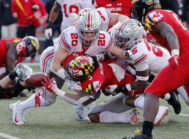 Maryland Terrapins running back Anthony McFarland (5) fumbles the ball into the end zone that Maryland Terrapins tight end Chigoziem Okonkwo (17) recovers for a touchdown after being tackled by Ohio State Buckeyes linebacker Pete Werner (20) and Ohio State Buckeyes safety Brendon White (25) during the 4th quarter of their game at Capital One Field at Maryland Stadium in College Park, Maryland on November 17, 2018. [Kyle Robertson/Dispatch]