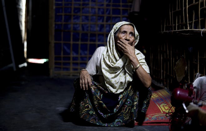 An elderly Rohingya refugee Noor Aisha Khatun, who used to visit spiritual healers, sits inside the family shelter in Kutupalong refugee camp, Bangladesh. [Altaf Qadri/AP]