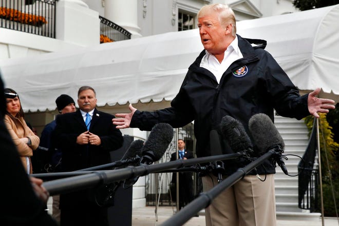 President Donald J. Trump answers questions from members of the media as he leaves the White House Saturday en route to see fire damage in California. [AP Photo / Jacquelyn Martin]